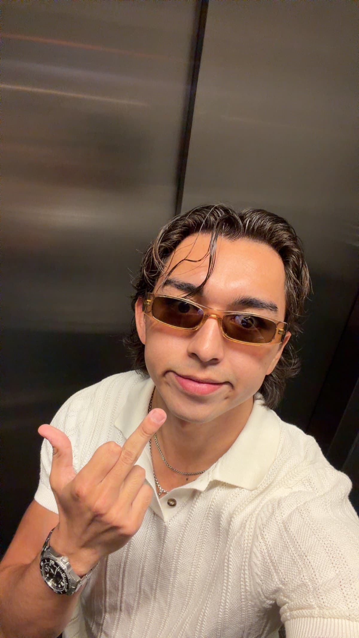 Elevator selfie in amber tinted glasses
